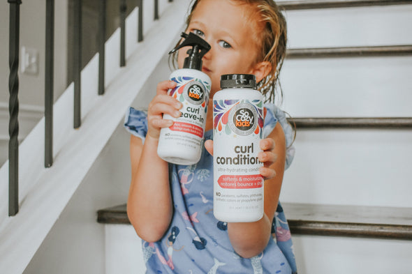 Little girl on stairsteps with Curl Conditioner and Curl Leave-In