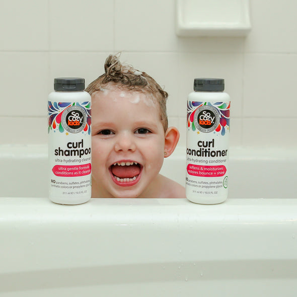 Child in bathtub with Curl Shampoo and Curl Conditioner